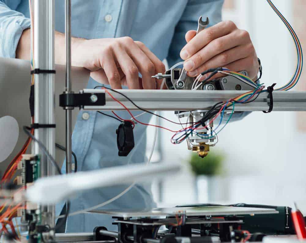 An engineer working on a 3D printer
