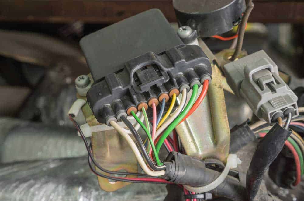 A wiring harness connected to an old car spare part