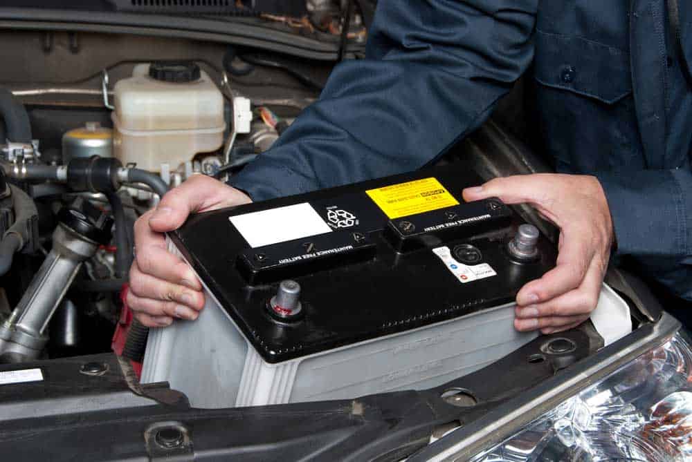 A mechanic replacing a car battery