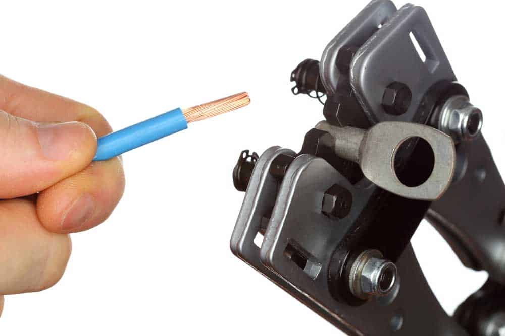 A crimping tool with a terminal in its die ready for pressing
