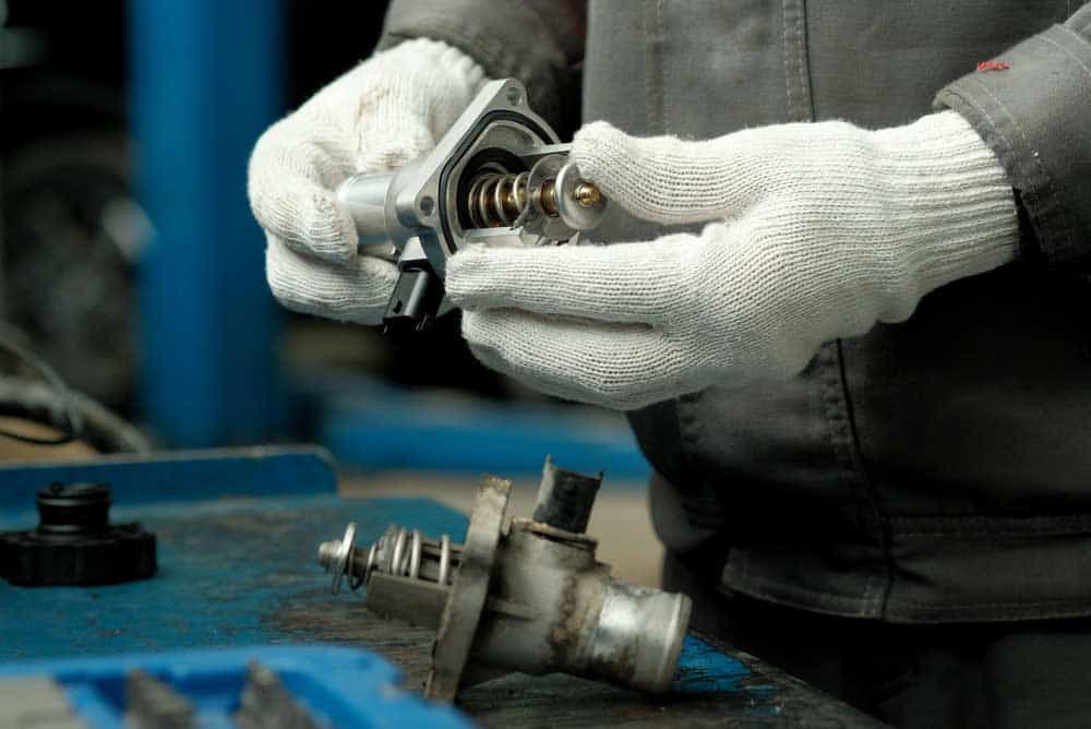 Fixing an automobile thermostat.