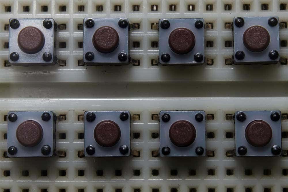 Multiple tactile push buttons inserted in a breadboard