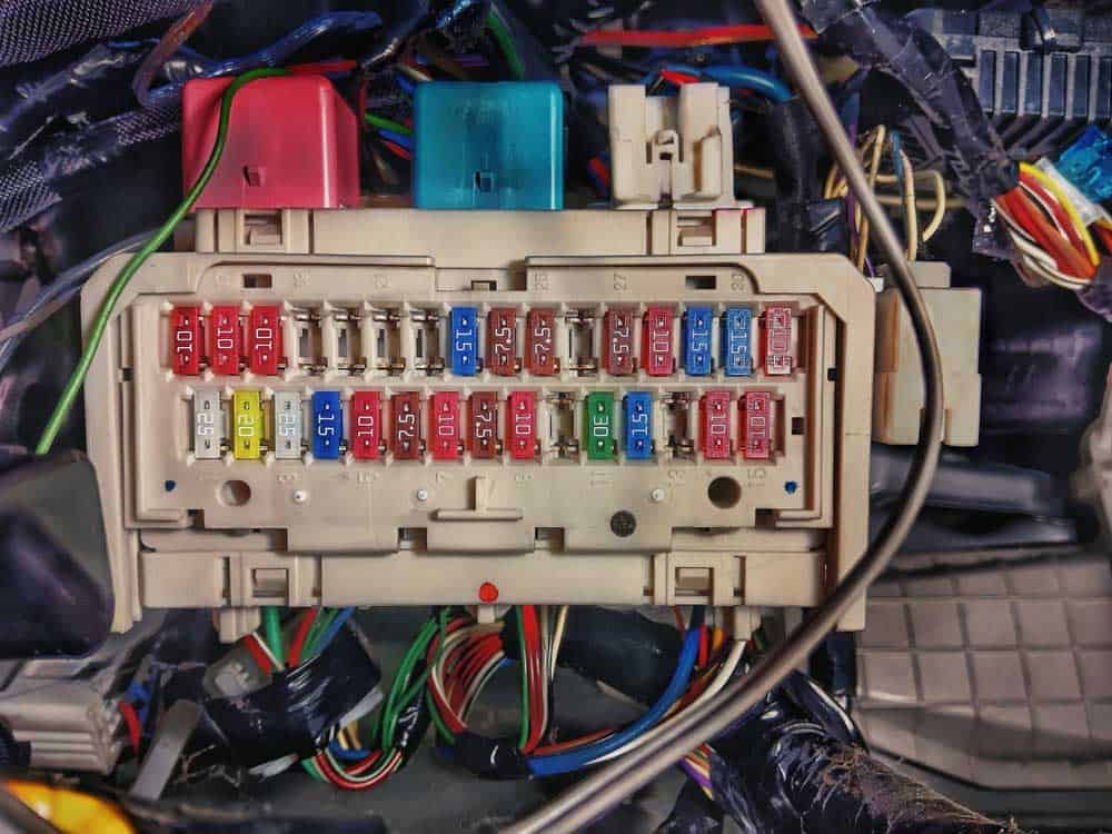 Organized wiring harness through an automotive relay box