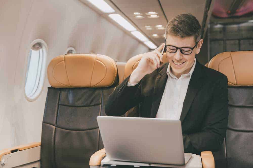 Businessman using internet in a private plane