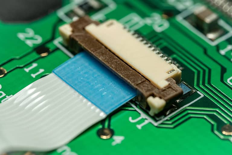 A flat ribbon cable connected to a PCB