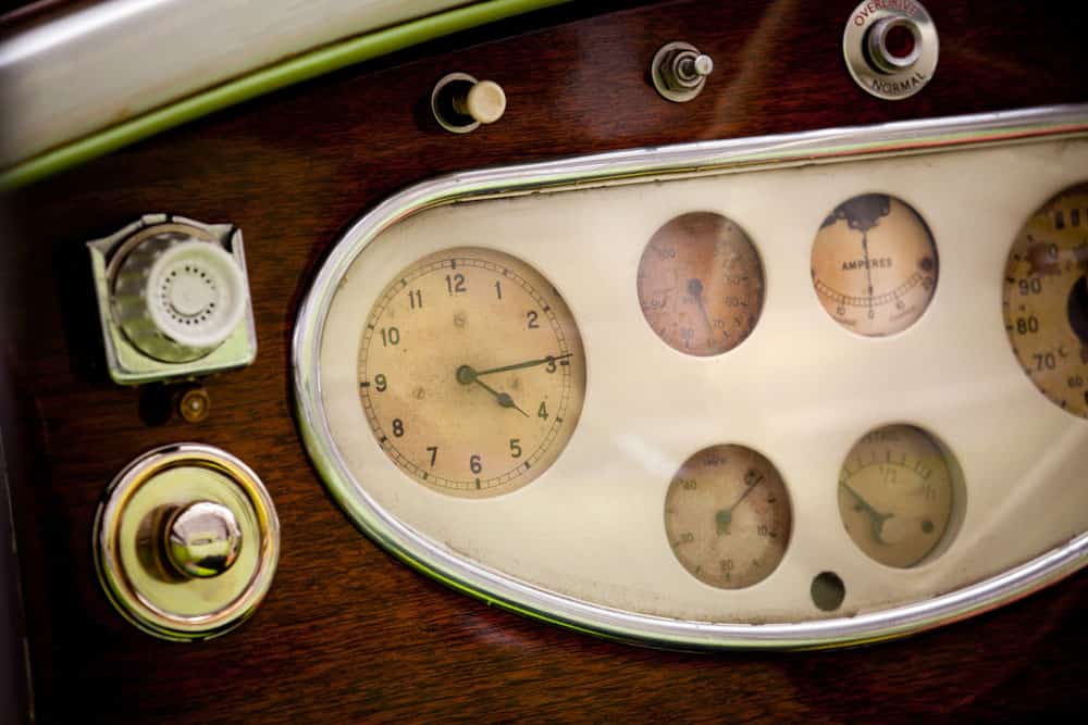 A vintage car’s instrument cluster with an ammeter