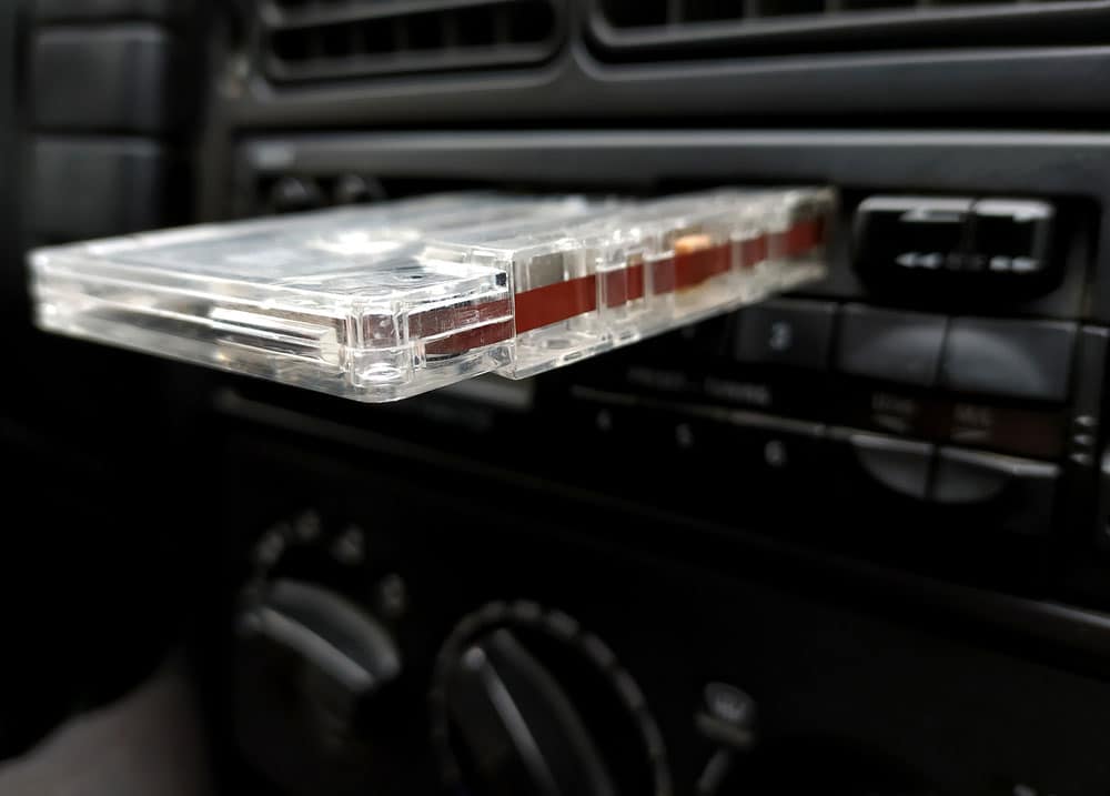 Vintage 90's cassette tape placed on a car radio cassette