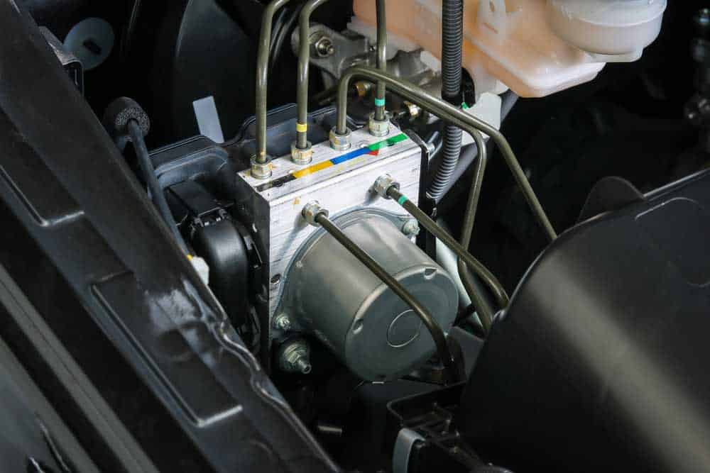 An ABS control unit in the engine bay