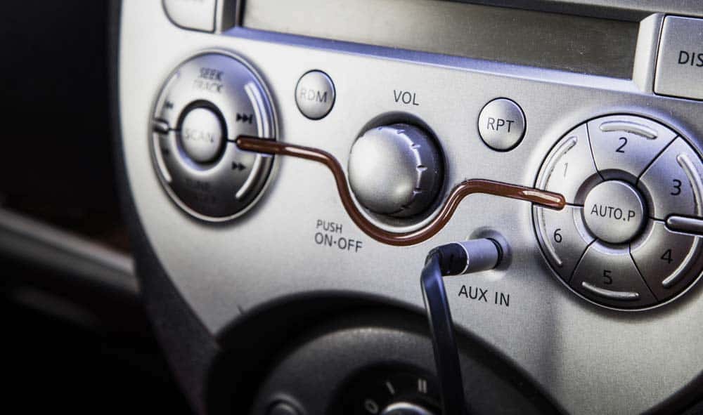 An AUX type of cable on a car dash. 