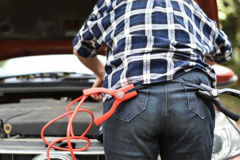 A technician with extension cable clips mounted in his jeans pockets
