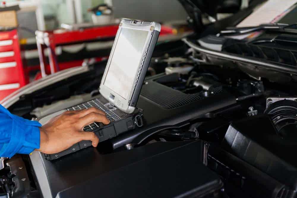 A mechanic using a professional diagnostic tool